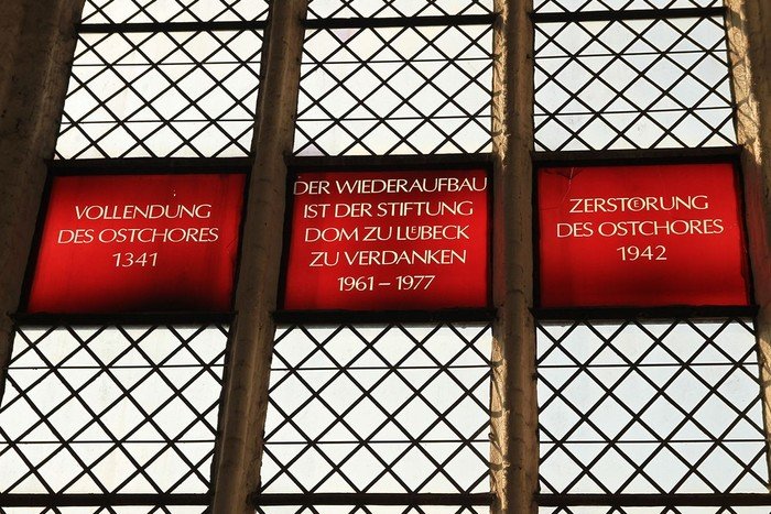 Symbolbild zur Unterseite für Besucher: zeigt Glasfenster, das an den Wiederaufbau des Ostchores erinnert